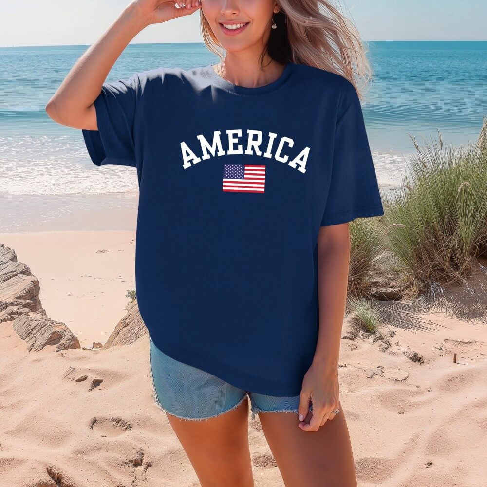 America T-shirt Navy. Short sleeve unisex t-shirt with American flag and "America" printed above it in white