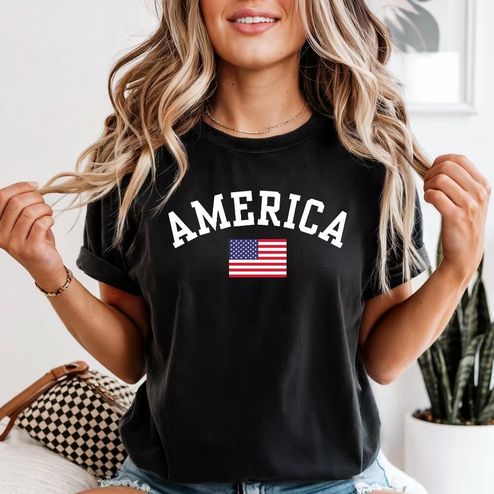 America T-shirt black color.  Short sleeve unisex t-shirt with American flag and "America" printed above it in white