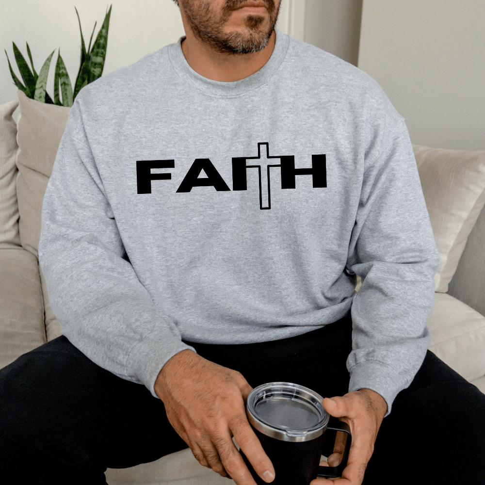 Faith Sweatshirt crewneck sport grey. On the front chest is printed "FAITH" in black with a cross as the "T"