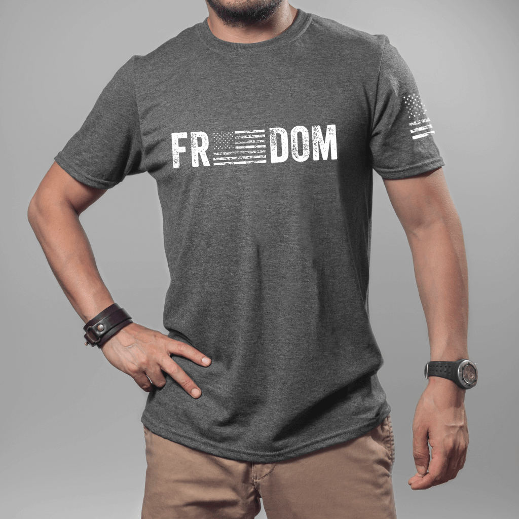 Unisex Freedom T-shirt, short sleeve dark heather.  "Freedom" is printed in white on the front chest with an American flag replacing the 'e's in the word.  American flag is also printed on the left sleeve.