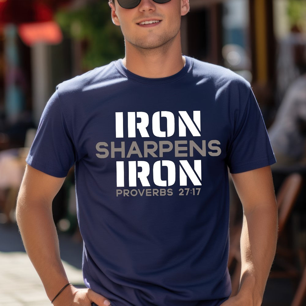 Unisex Iron Sharpens Iron T-shirt navy color. "Iron Sharpens Iron Proverbs 27:17" design printed on front in white and grey.