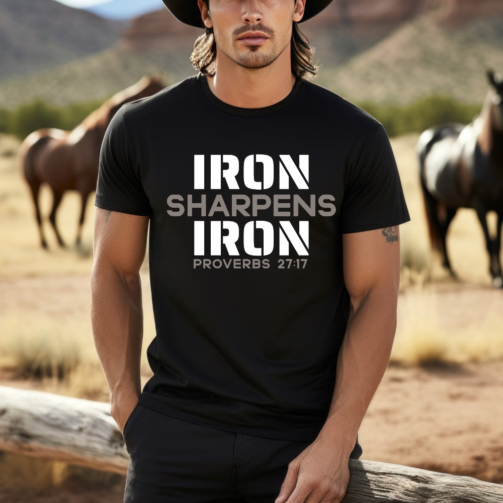 Unisex Iron Sharpens Iron T-shirt black color. "Iron Sharpens Iron Proverbs 27:17" design printed on front in white and grey.