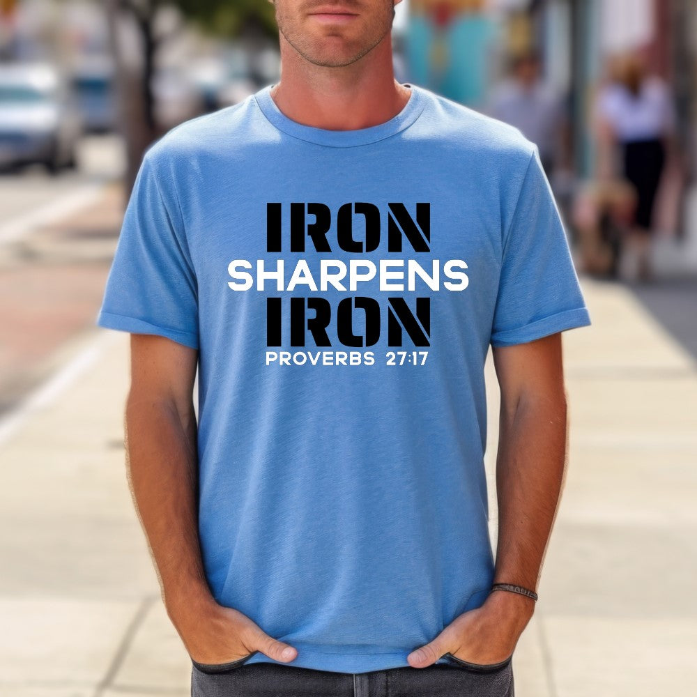 Unisex Iron Sharpens Iron T-shirt heather indigo color. "Iron Sharpens Iron Proverbs 27:17" design printed on front in white and black.