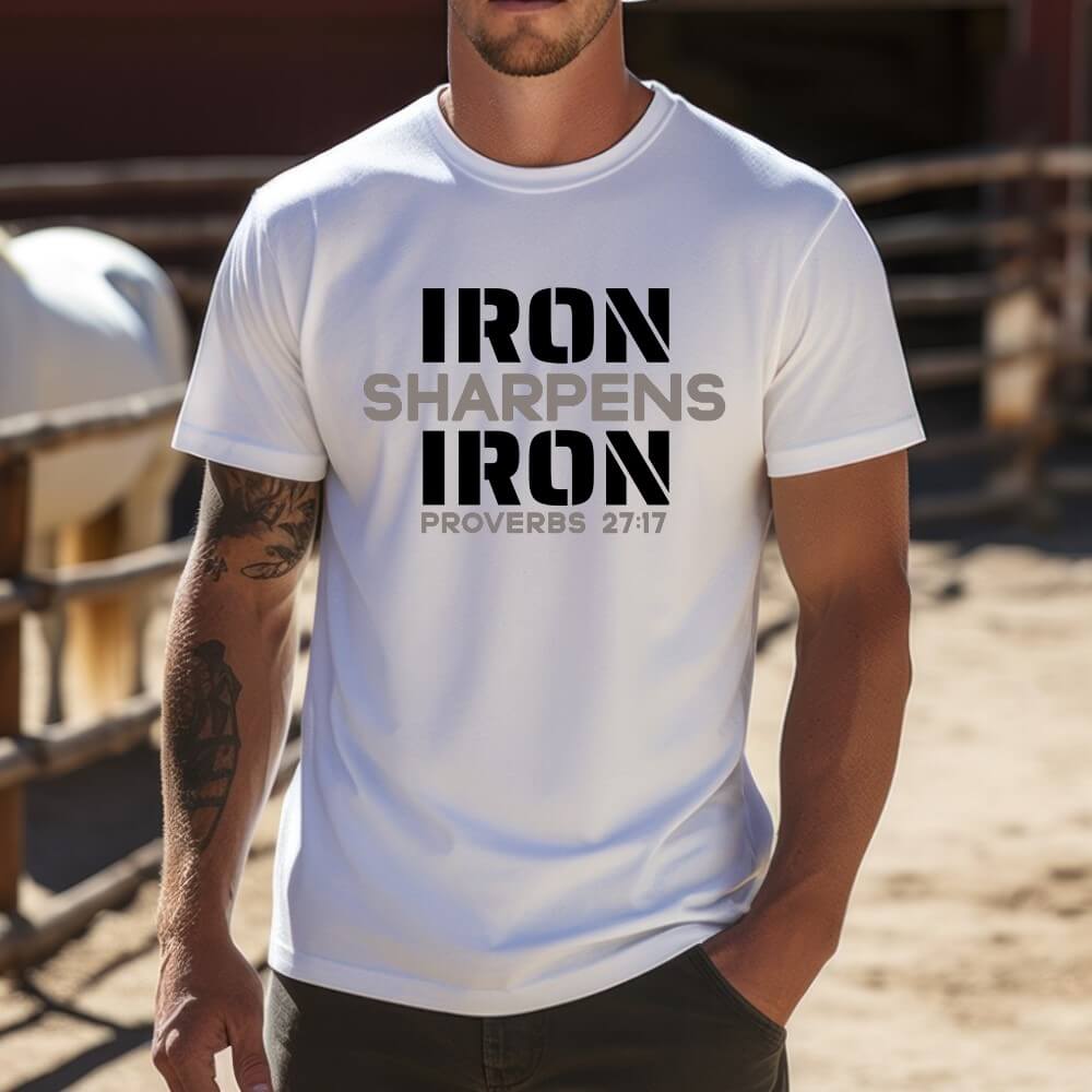 Unisex Iron Sharpens Iron T-shirt white color. "Iron Sharpens Iron Proverbs 27:17" design printed on front in grey and black.
