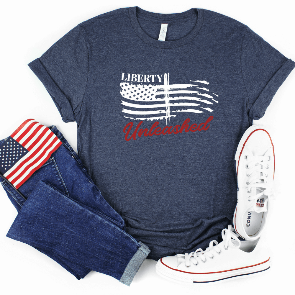 Liberty Unleashed Unisex T-shirt short sleeve heather midnight navy.  White American flag on the front chest with a cross in the middle and "Liberty Unleashed" printed above and below the flag.