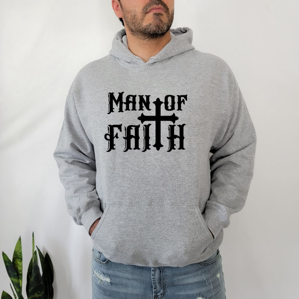 Man of Faith Hoodie sport grey. On the front chest is printed "Man of Faith" in black font with a cross as the "t".