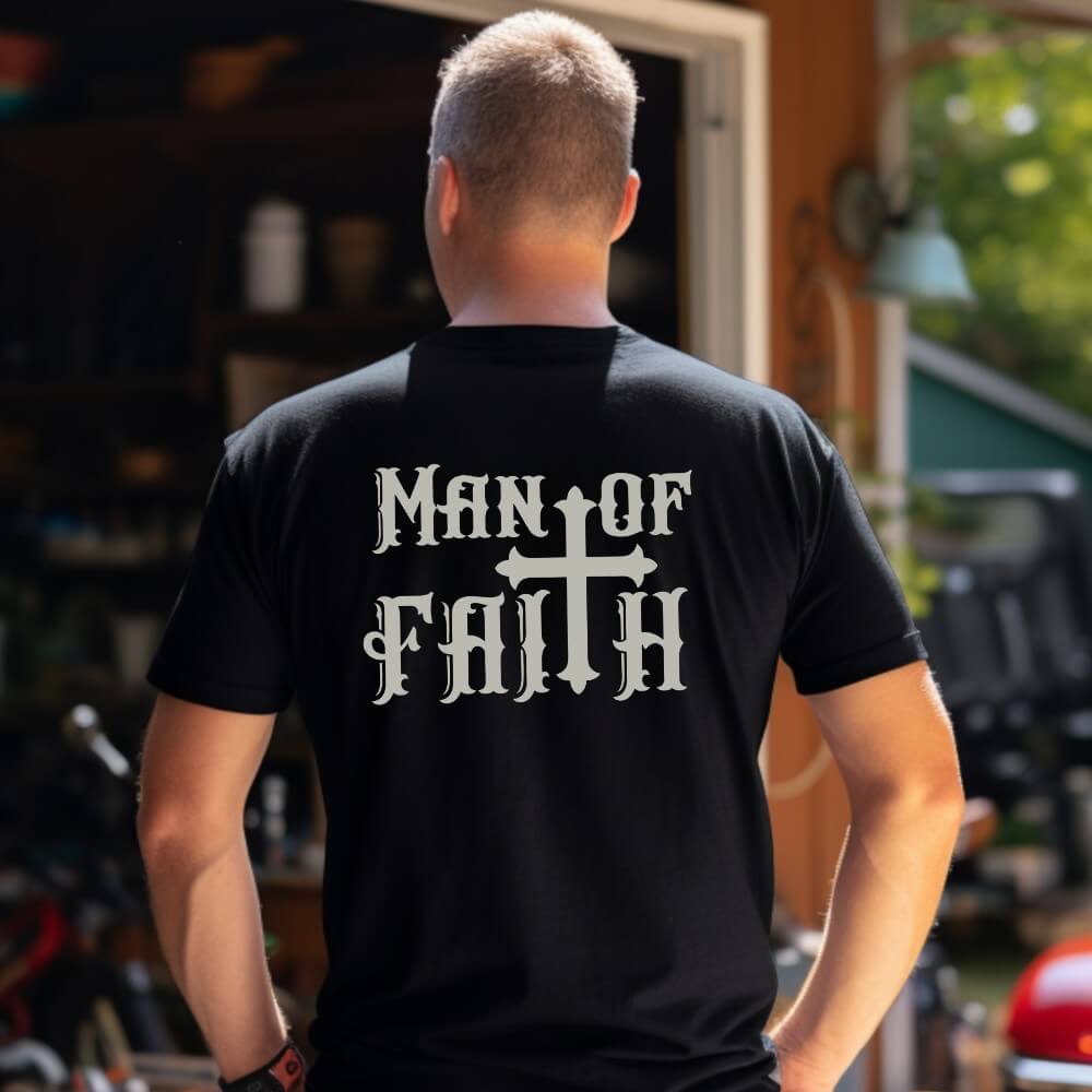 Man of Faith Shirt black, short sleeve. On the back is printed "Man of Faith " in grey with a large cross as the 'T' in 'Faith"
