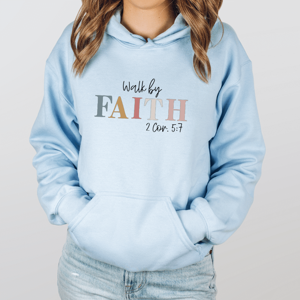 Walk By Faith hoodie light blue. On the front chest is printed "Walk by FAITH 2 Cor. 5:7" in multicolored pastels.
