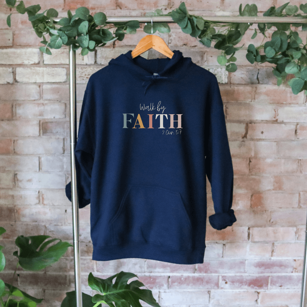 Walk By Faith hoodie navy. On the front chest is printed "Walk by FAITH 2 Cor. 5:7" in multicolored pastels.