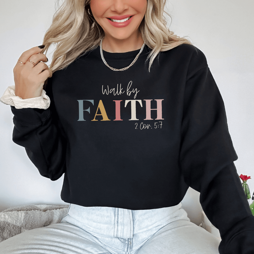 Walk By Faith crewneck sweatshirt black.  On the front chest is printed "Walk by FAITH 2 Cor. 5:7"