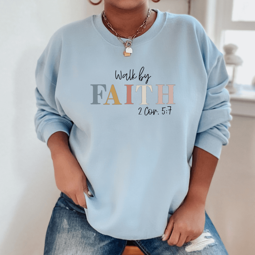 Walk By Faith crewneck sweatshirt light blue. On the front chest is printed "Walk by FAITH 2 Cor. 5:7"