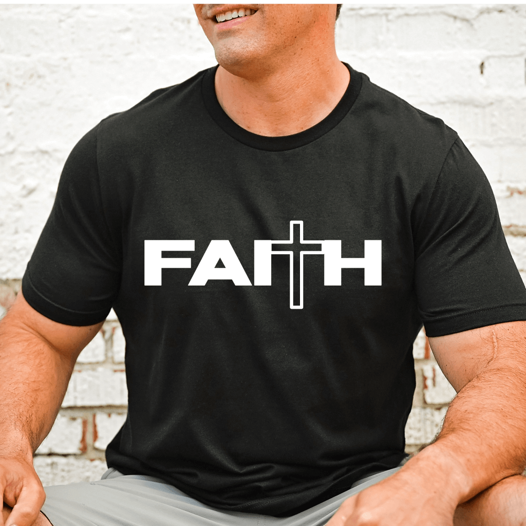 Unisex Faith T-shirt black, short sleeve. "Faith" is printed in white font on the front chest. A cross is in place of the "t'. 