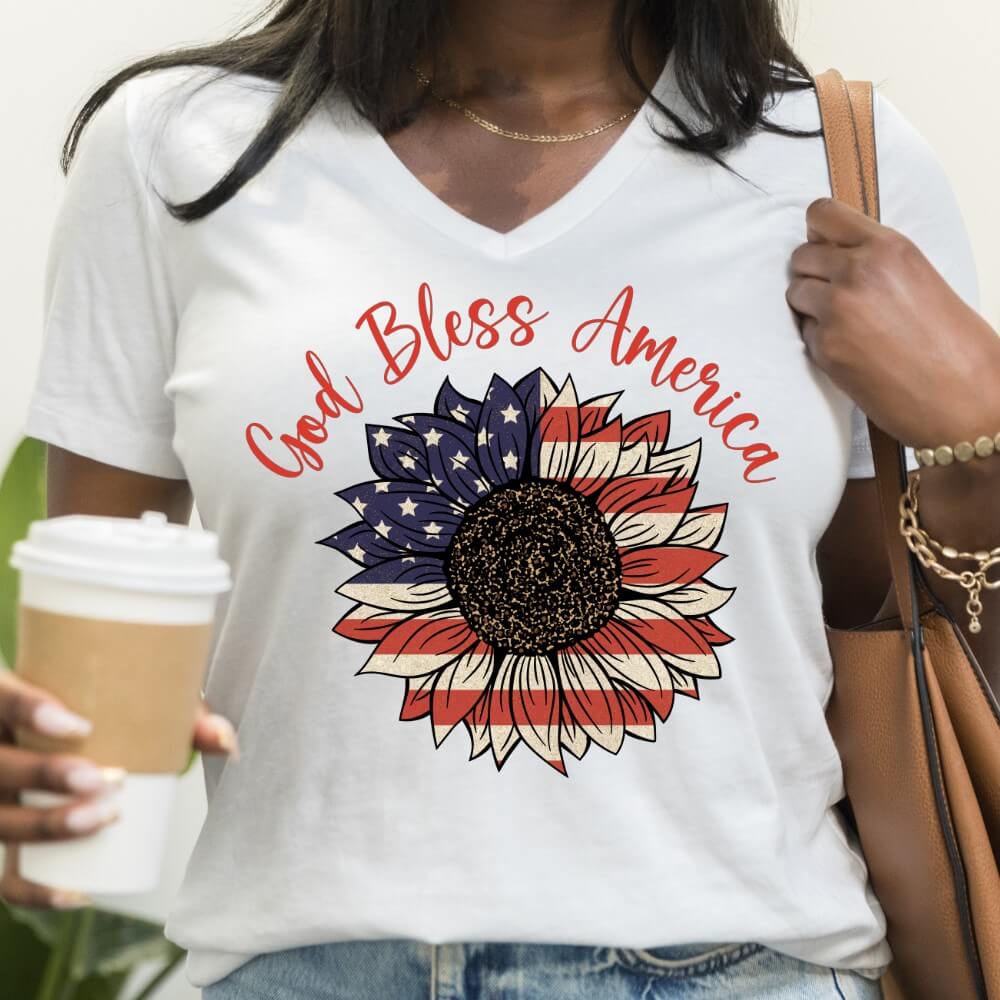 God Bless America V-neck women's t-shirt white. American Flag colored sunflower printed on front chest below "God Bless America" in red
