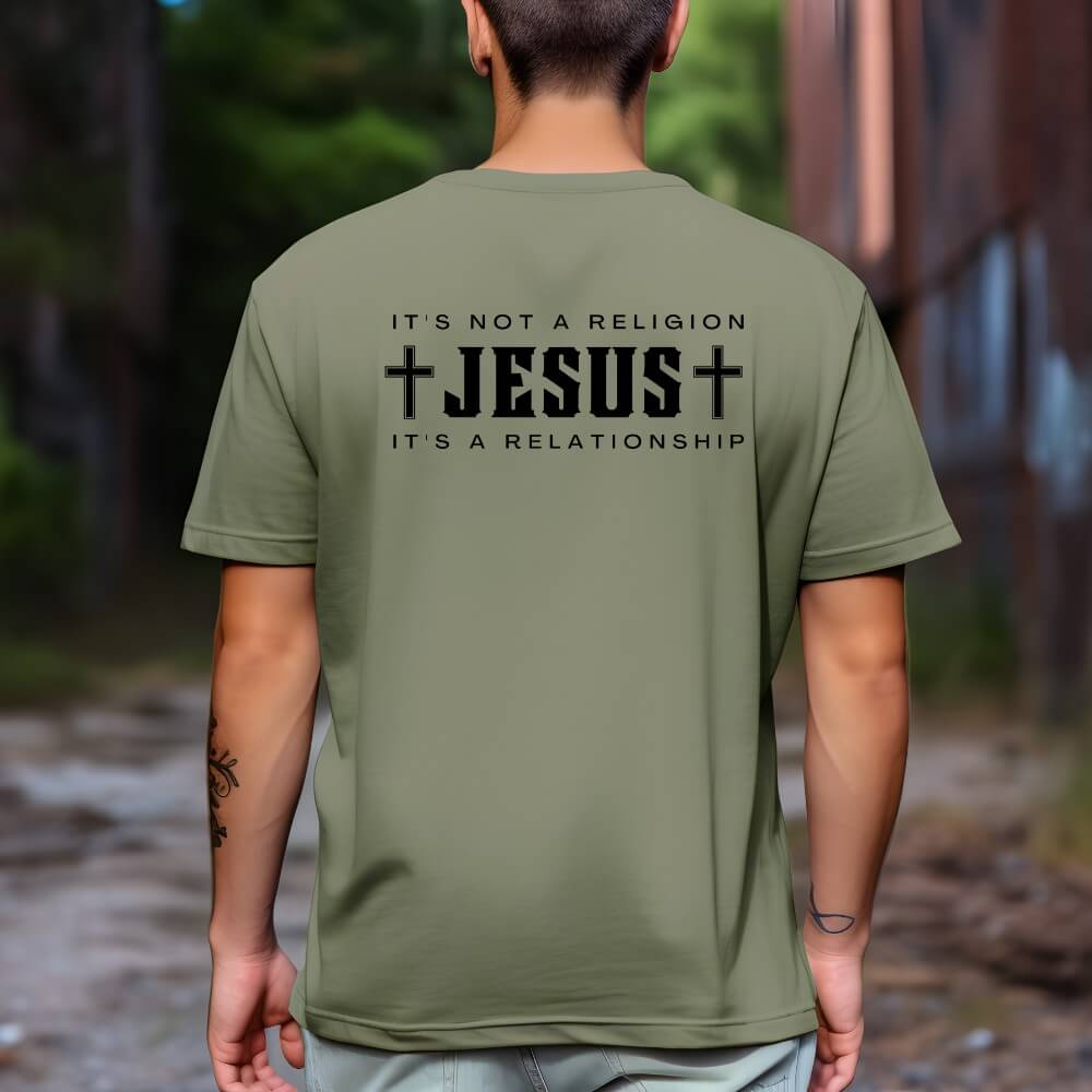 Not a Religion Shirt Military green short sleeve. On the back is printed "Jesus" in large black font with crosses on each side. "It's not a religion, It's a Relationship" is printed above and below "Jesus" 
