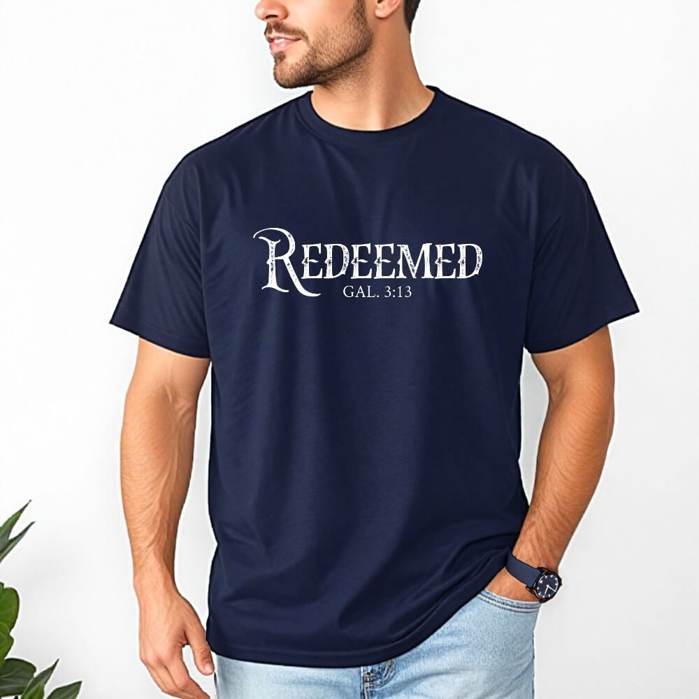 Unisex Redeemed t-shirt navy. Short sleeve t-shirt with &#39;Redeemed - Gal. 3:13) printed in white on the front chest. 