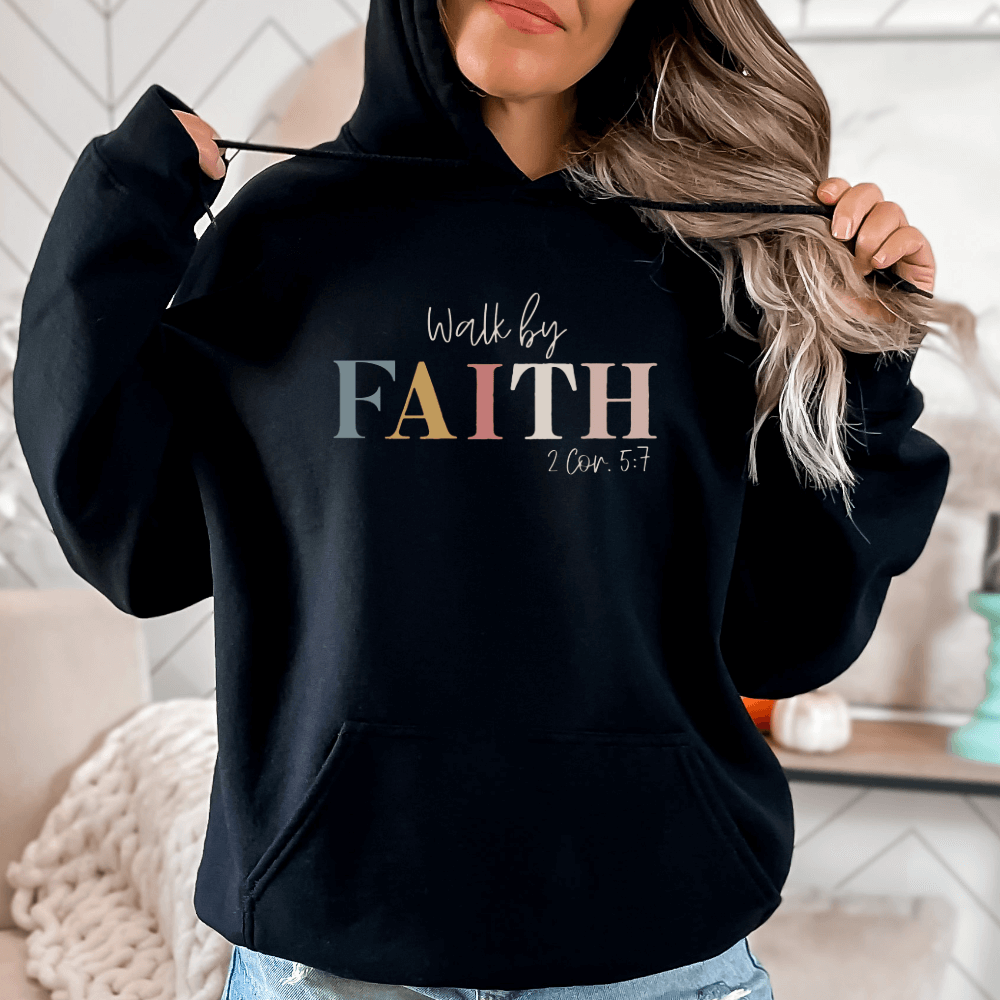 Walk By Faith hoodie black. On the front chest is printed "Walk by FAITH 2 Cor. 5:7" in multicolored pastels.