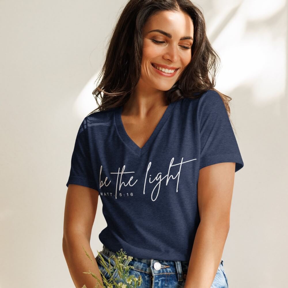 Be The Light women&#39;s V-neck t-shirt heather navy short sleeve.   &quot;be the light - Matt. 5:16&quot; printed in white on front chest. 